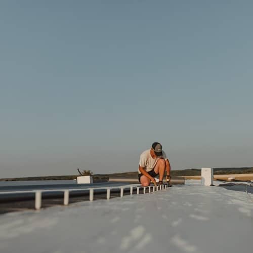 Roofer installs TPO roofing.