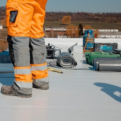 Roofer installing TPO